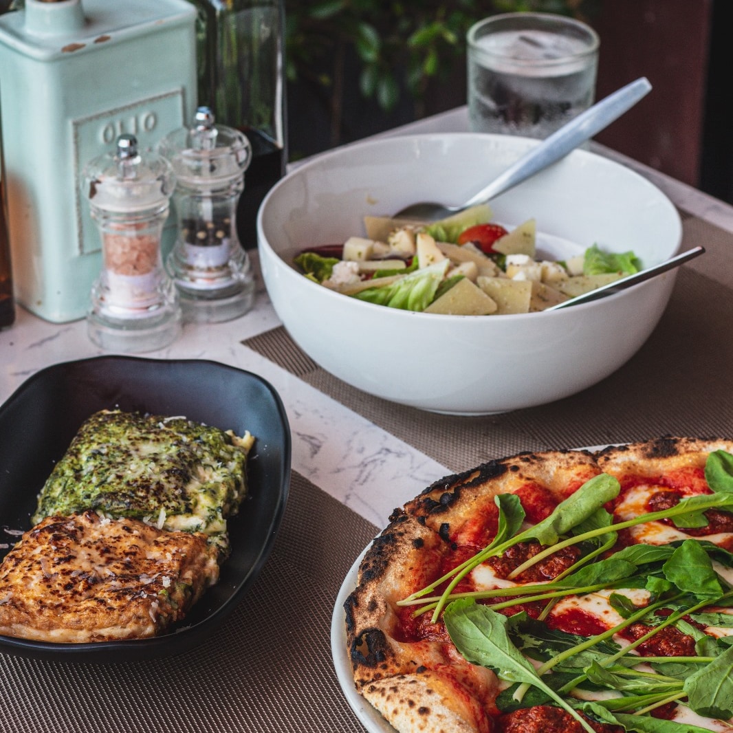 Pizza with arugula, focaccia and salad